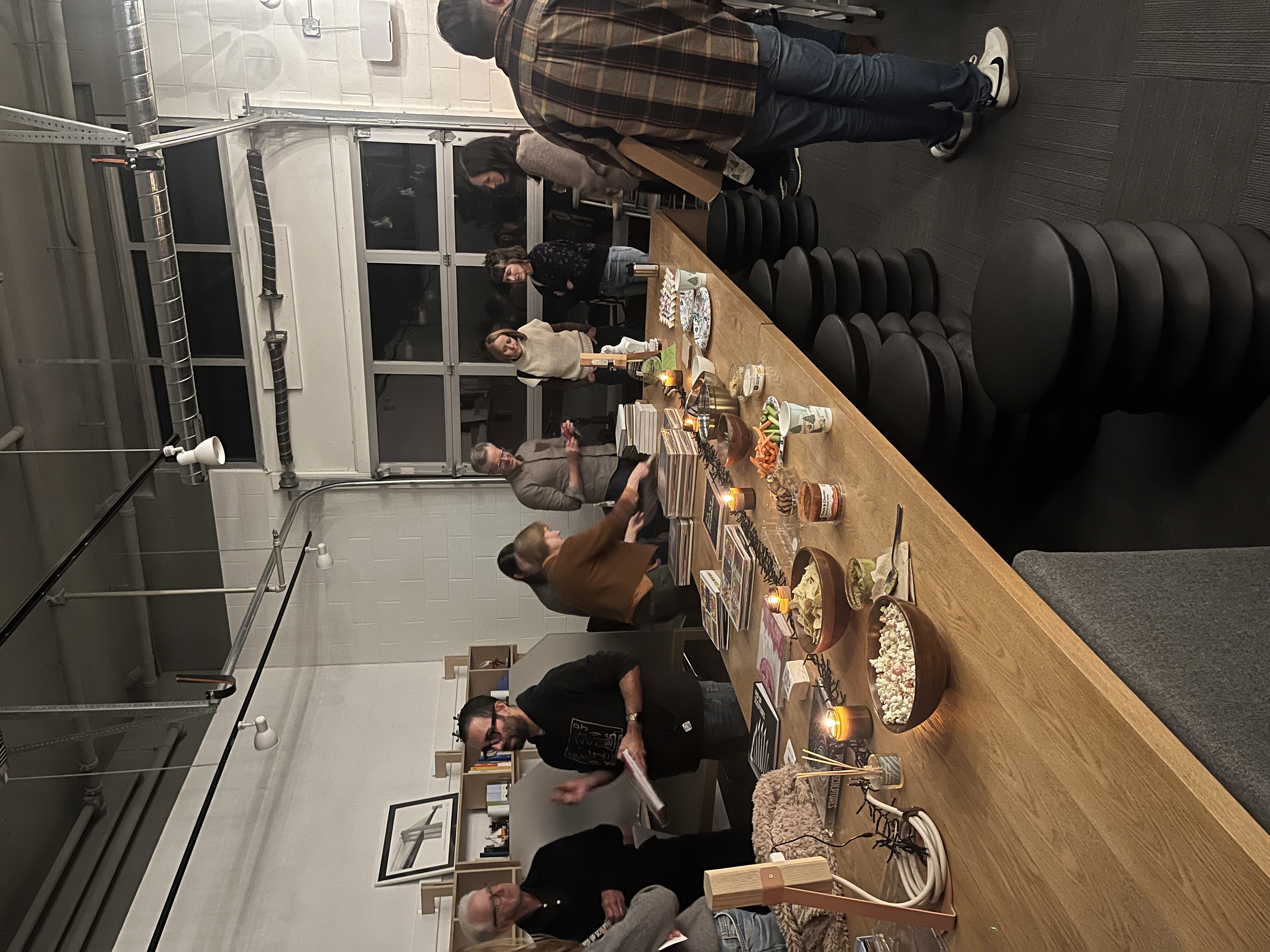 Evening gathering at Roost, long oak table with food and candles